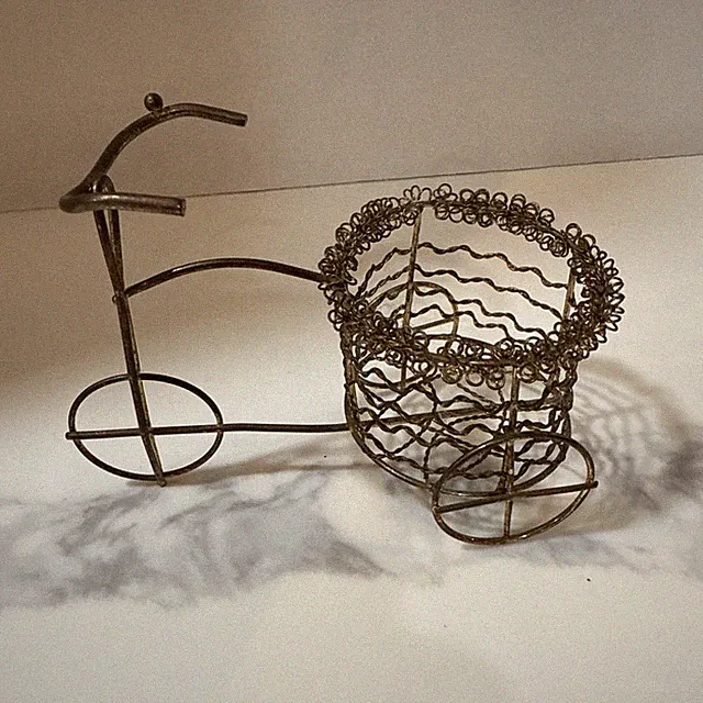 This is a vintage wire tricycle